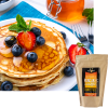 Pancakes topped with blueberries next to a family-size package of Kowalski's Buttermilk Pancake Mix