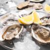 Raw oysters with lemon wedges