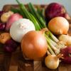 A variety of onions in various shapes, colors, and sizes