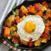 Egg sunny-side up over sweet potato hash
