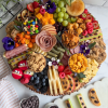 The Board Loon's After-School Snacking Board garnished with fresh flowers