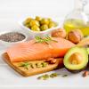 Low-carb foods, including salmon, avocado, olives, and pepitas