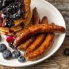 Five of our Signature Market Sausage Breakfast Links alongside a stack of blueberry pancakes
