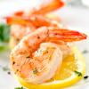 Marinated shrimp shrimp garnished with fresh snipped herbs and paired with a fresh lemon slice